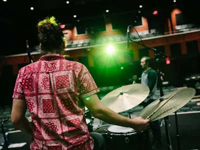 performers on stage inside theatre