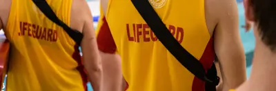 three lifeguards wearing yellow lifeguard gear