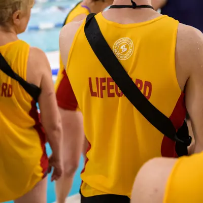 three lifeguards wearing yellow lifeguard gear