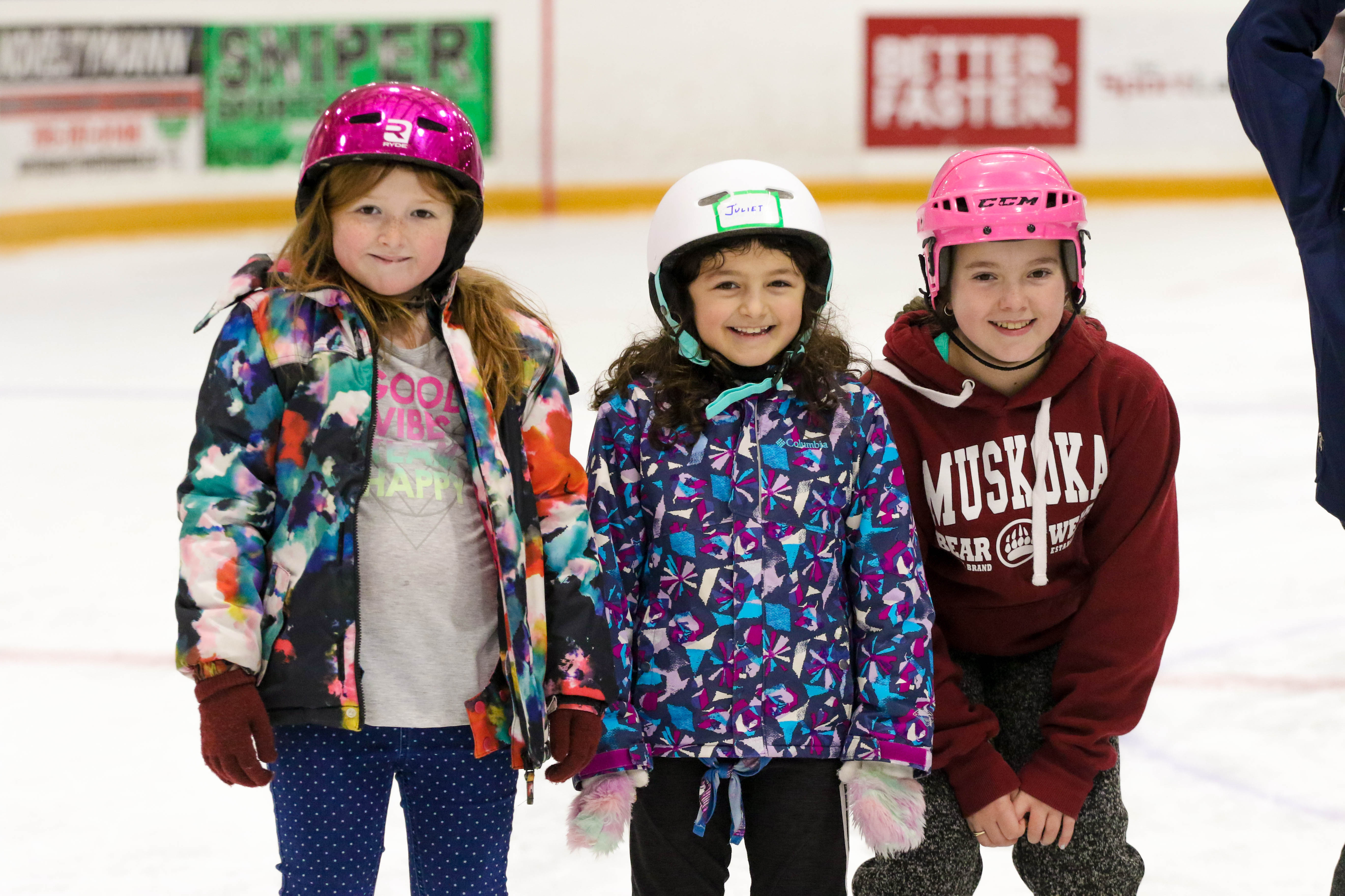three youths taking photo together while ice skating